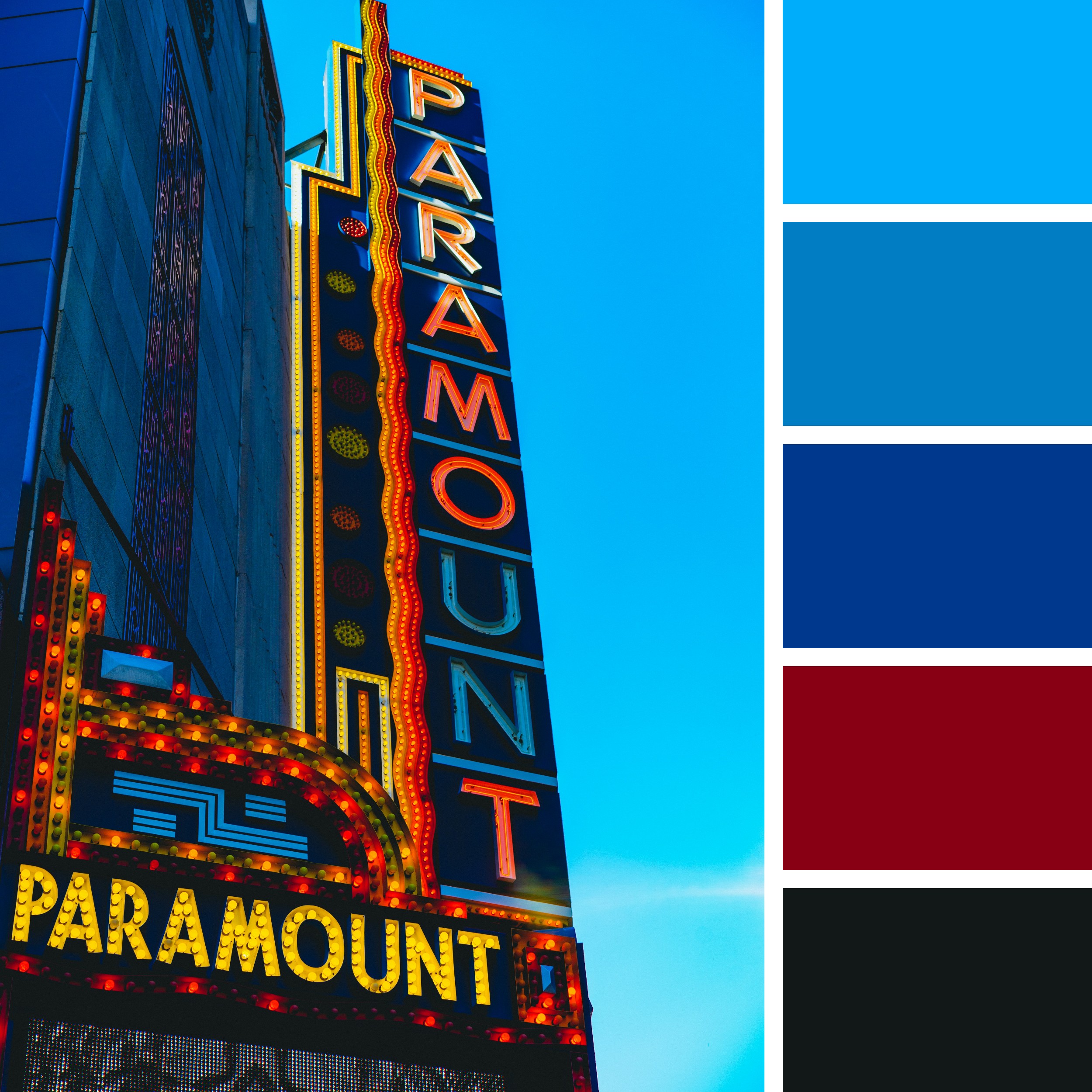 A grand vertical sign, emblazoned with bright yellow and red lights, stands prominently against a deep blue sky that transitions to near black